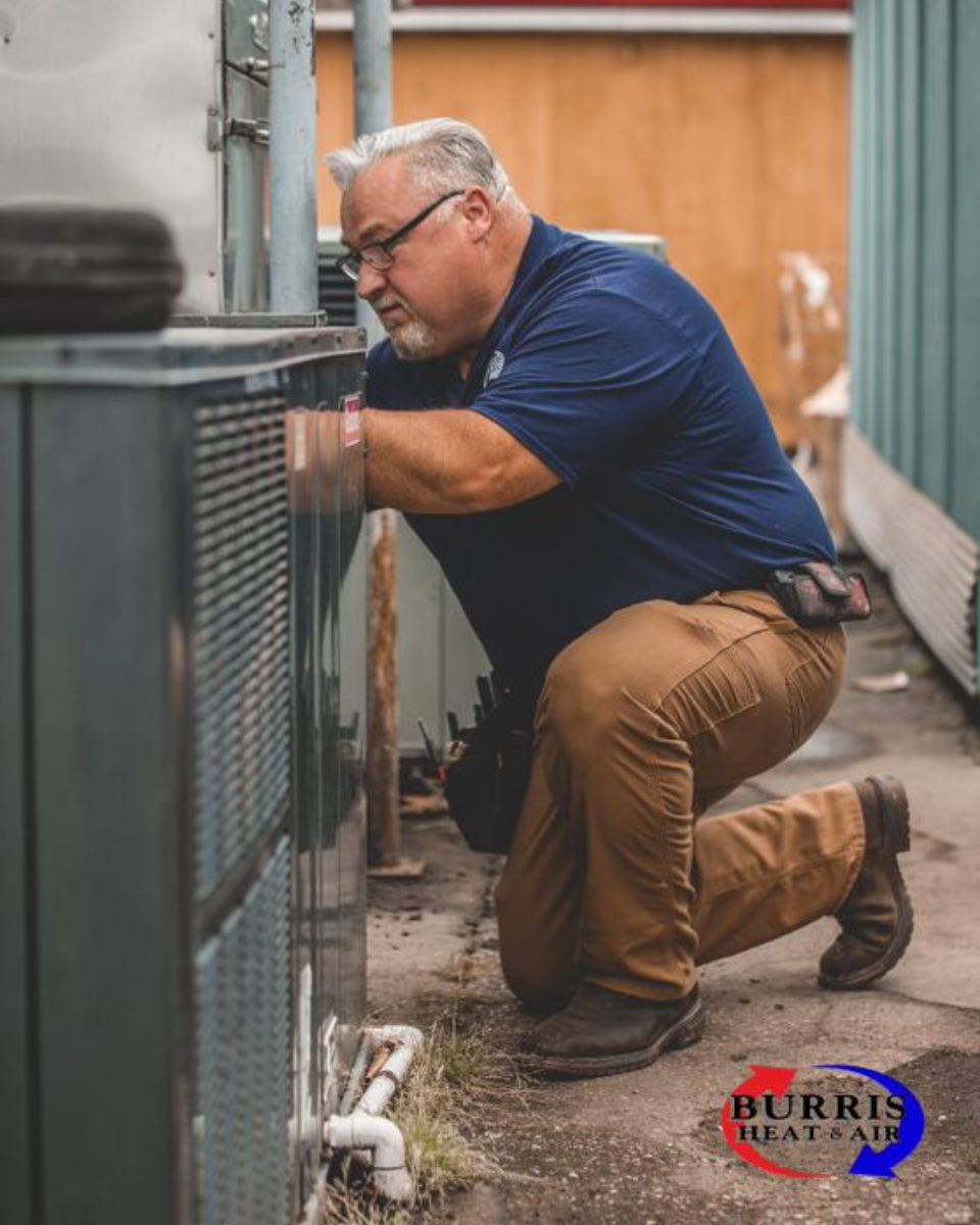 Burris Heat & Air HVAC technician installing an HVAC system.