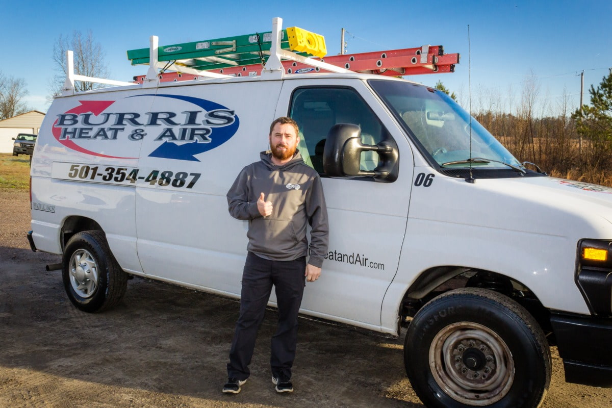 Burris Heat & Air worker standing next to their van.